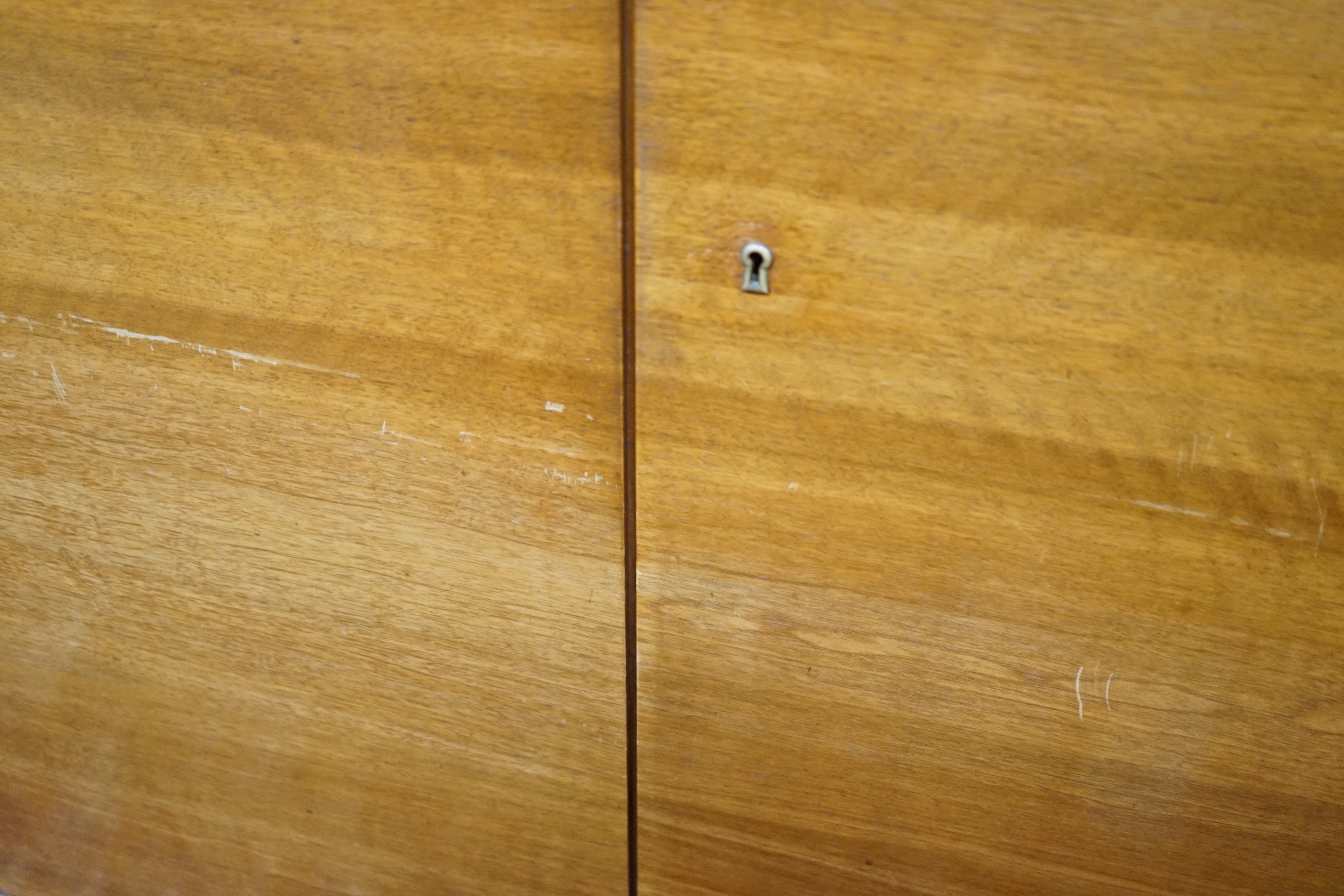 A mid century walnut two door cabinet, by Georg Schoettle, Stuttgart, width 135cm, depth 40cm, height 160cm